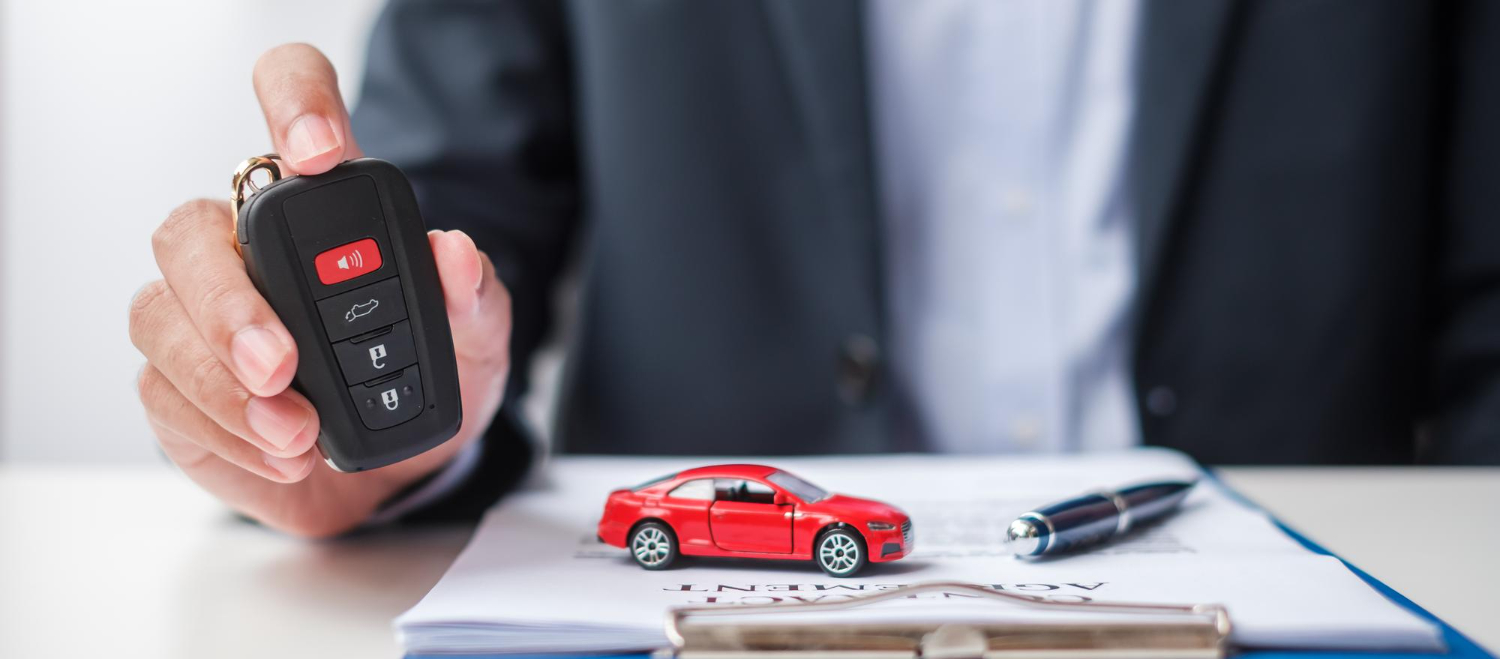 businessman-hand-holding-remote-keyless-with-car-toy-pen-contract-document-buy-sale-insurance-rental-contract-agreement-concepts
